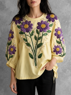 Blouse femme jaune brodée à perles avec manches bouffantes et col rond