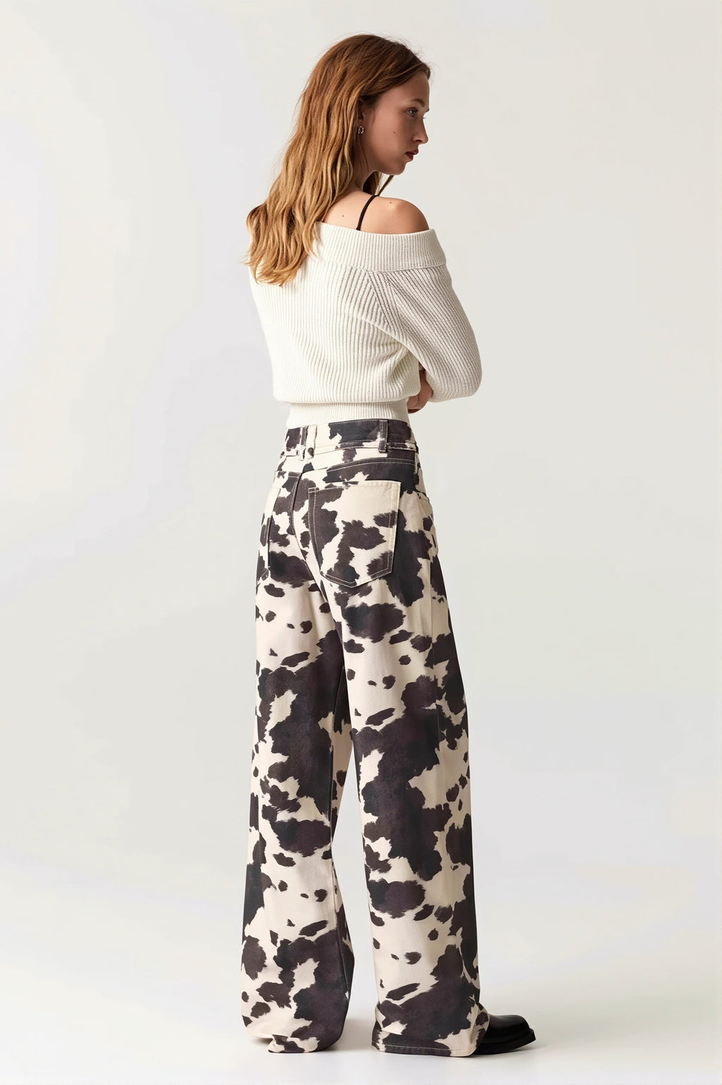 Détail du denim délavé avec motif vache sur jean taille haute femme
